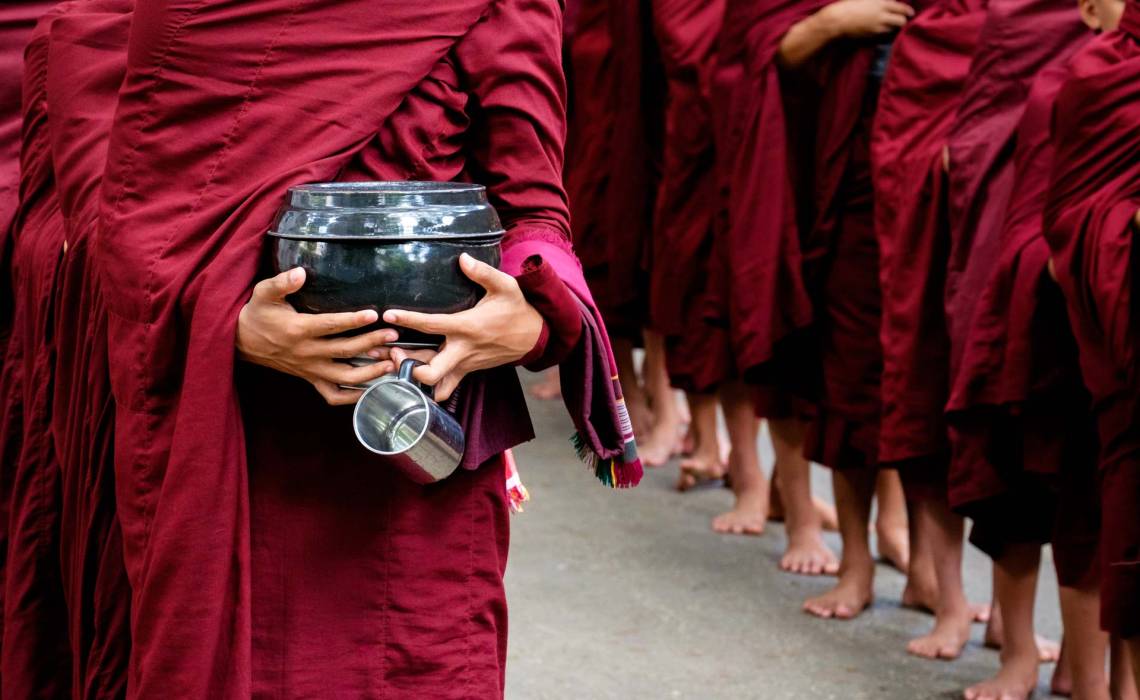 detail-of-buddhist-monks-crowd-and-person-holding-PKCY67V.jpg