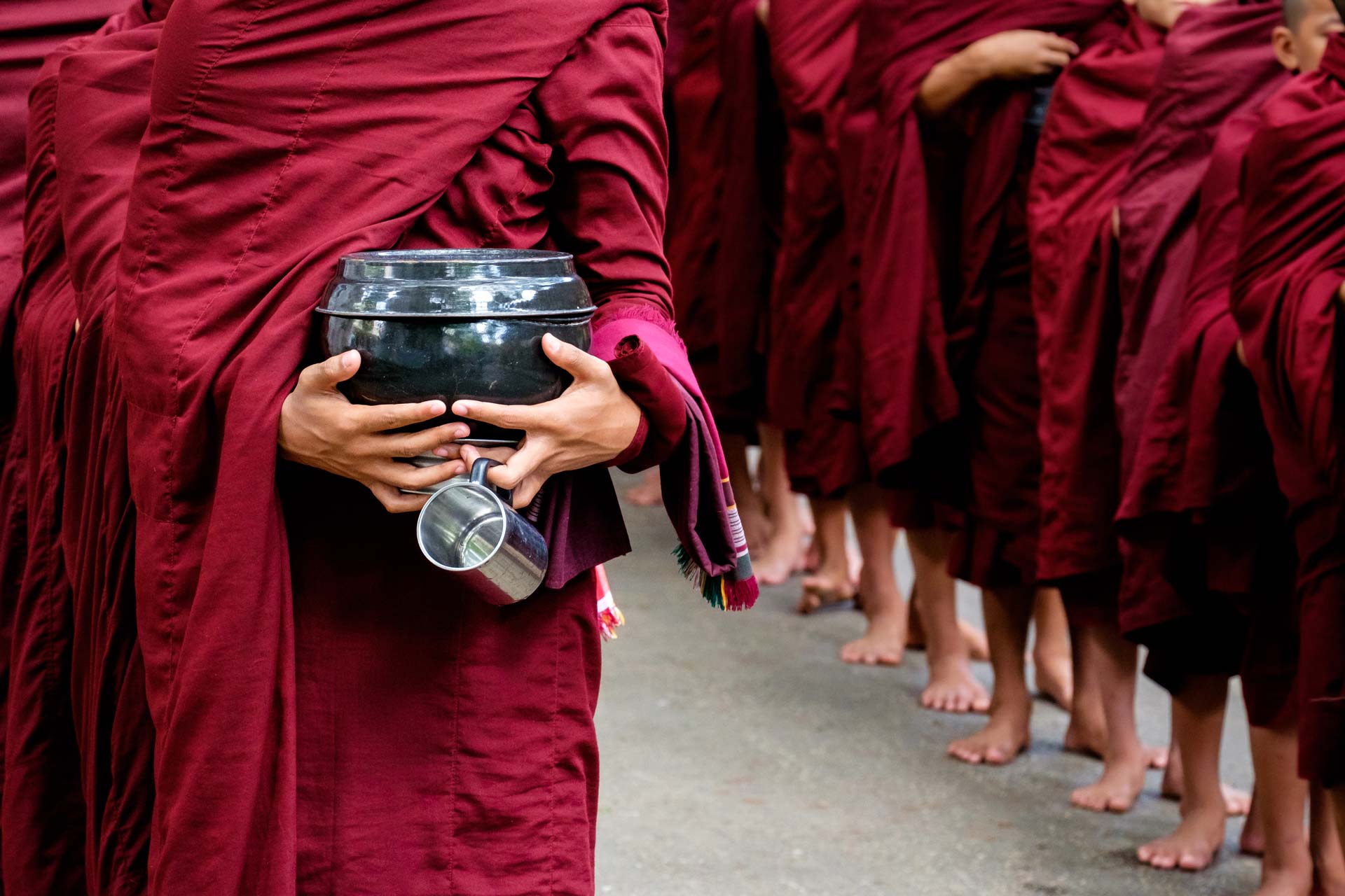 detail-of-buddhist-monks-crowd-and-person-holding-PKCY67V.jpg